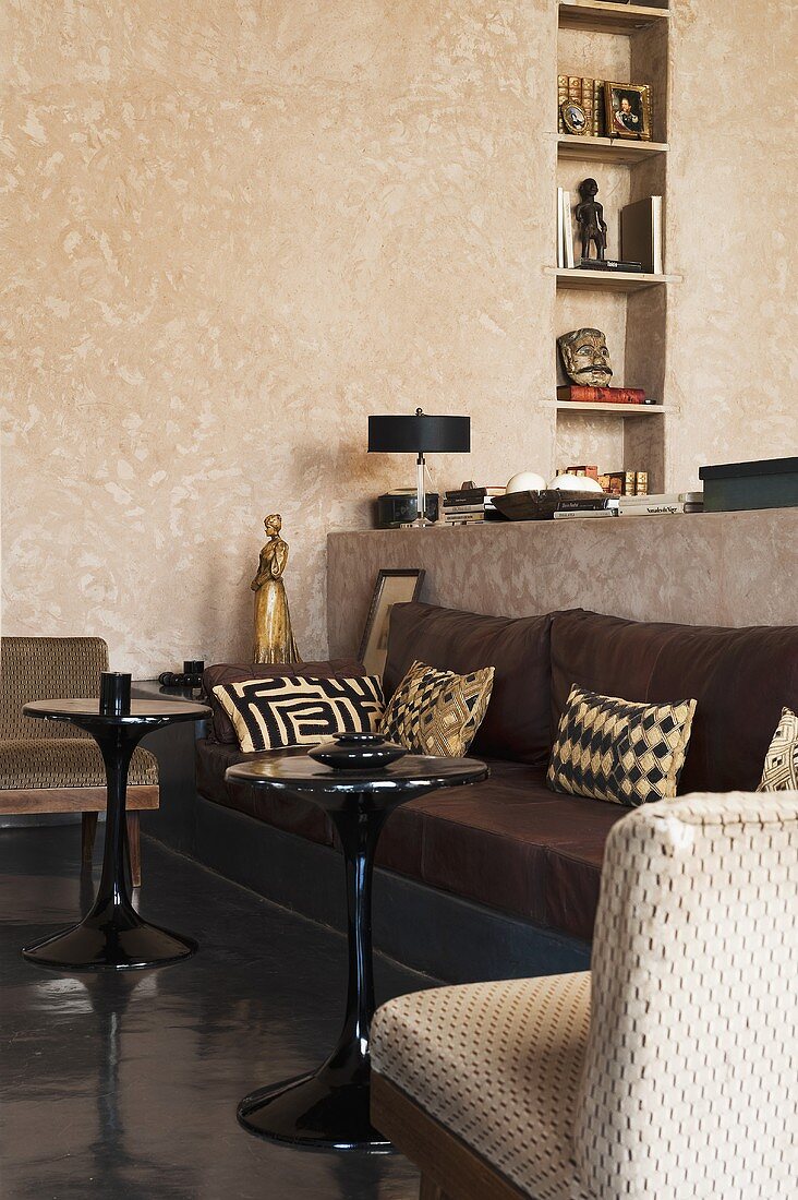 A cushion on a bench with a side table in a Mediterranean living room