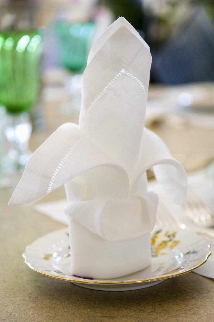 A folded napkin on a saucer
