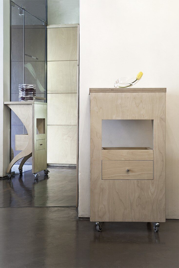 A rolling cupboard in an anteroom with a polished screed floor