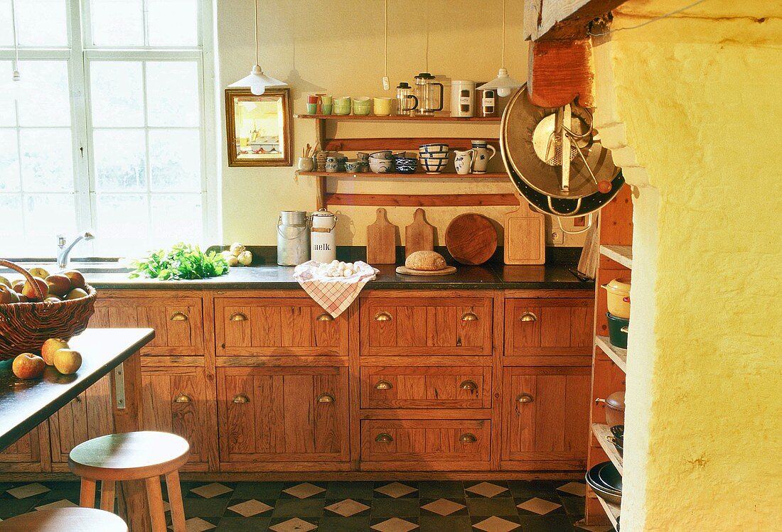 A kitchen in a farm house - a kitchen counter with old wooden drawers