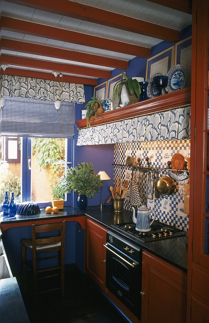 A mini kitchen with mahogany cupboards and tiled walls