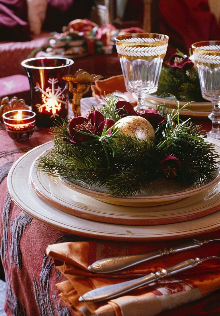 Christmas decorations on a place setting with wine glasses