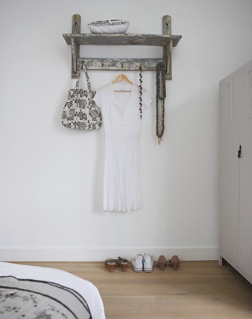 Rustic wardrobe with white dress in a bedroom