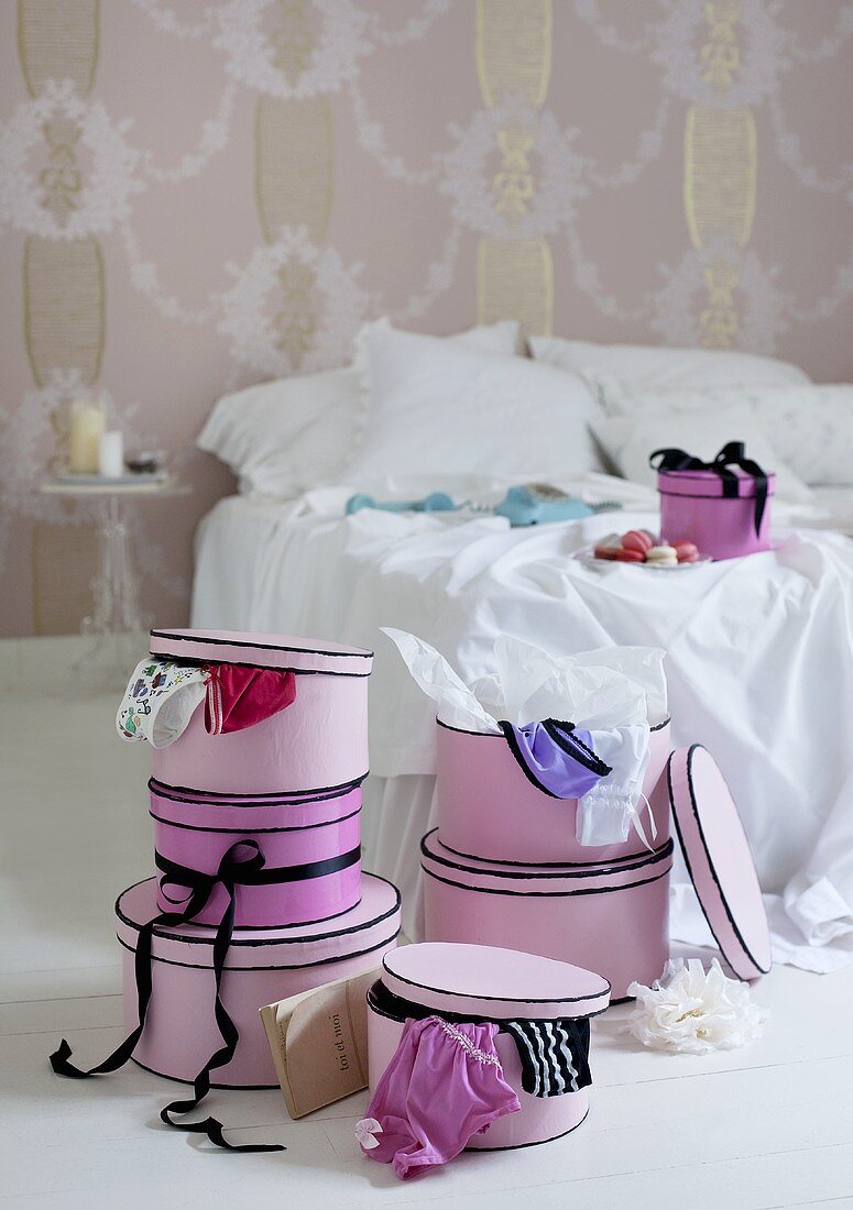 A set of pink boxes in a bedroom