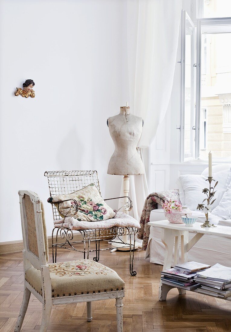 Assorted chairs and dress mannequin at the window