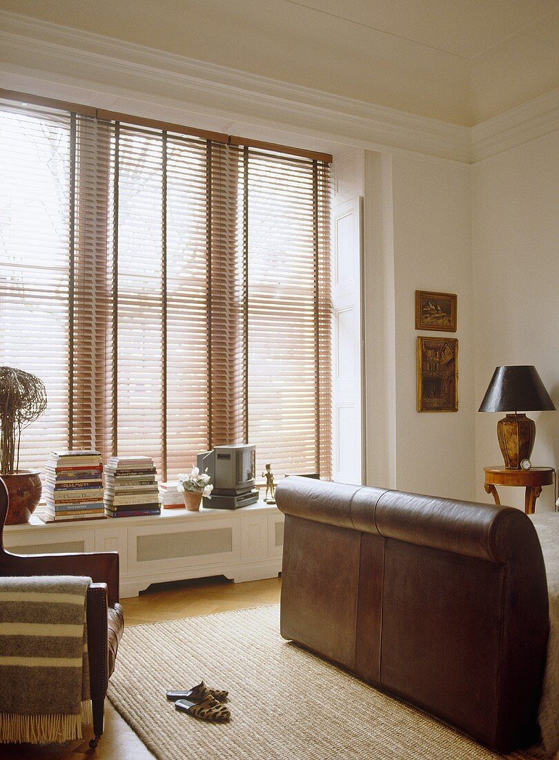 Leather upholstered bed next to window