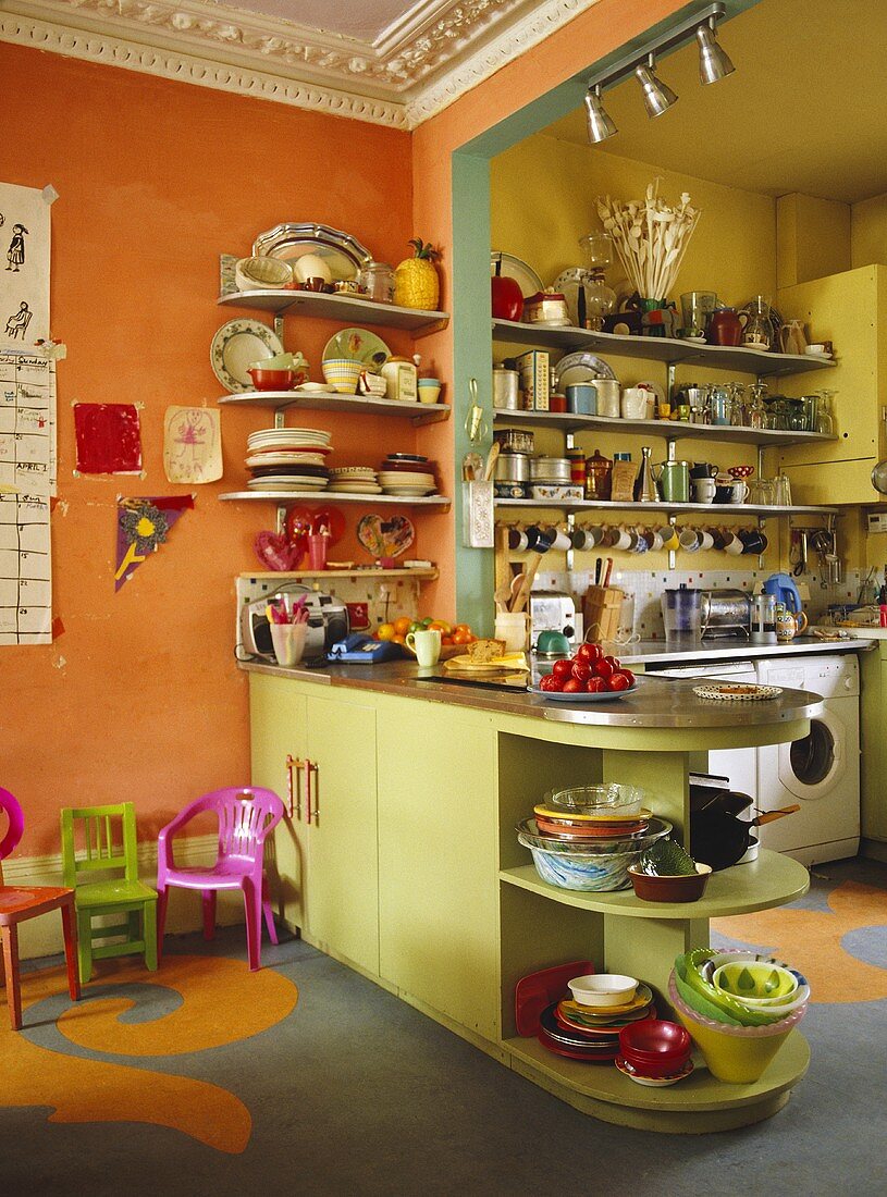 Grüner Küchenblock im Fiftiesstil mit Blick durch Durchgang auf offene Küche