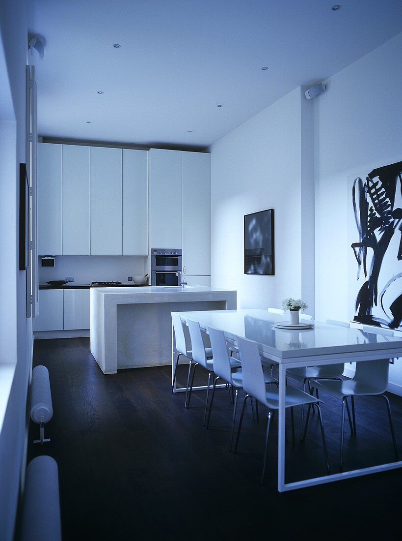 Minimalist kitchen in white with table and chairs