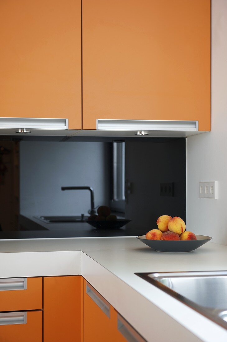 Modern kitchen with orange units