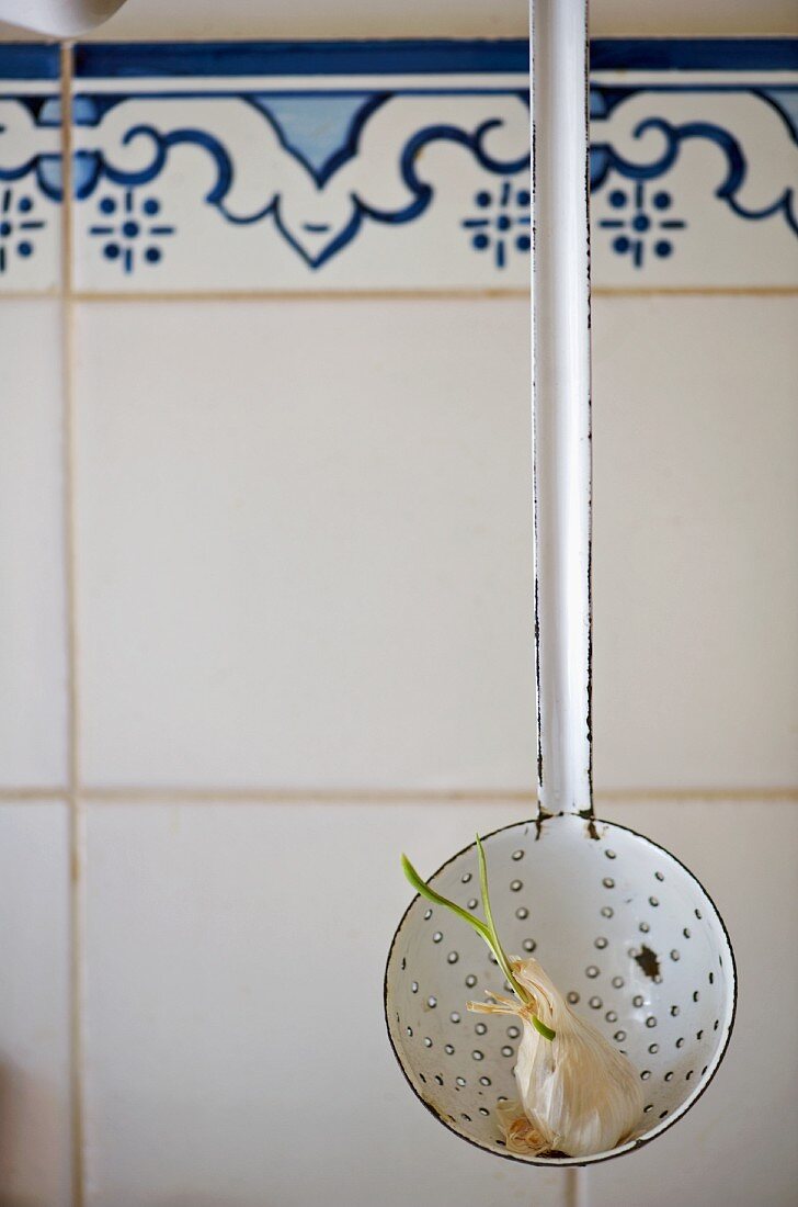 An old-fashioned enamel draining spoon