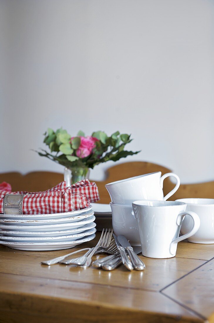 Tableware and cutlery on wooden table
