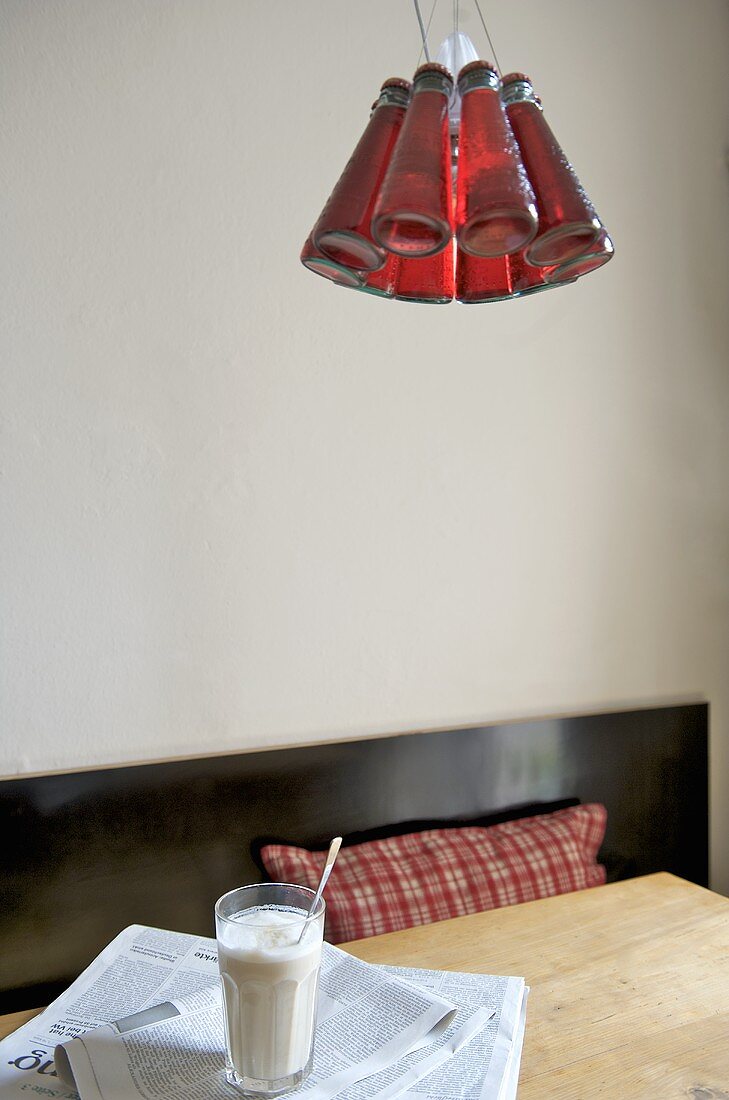 Red ceiling light above wooden table