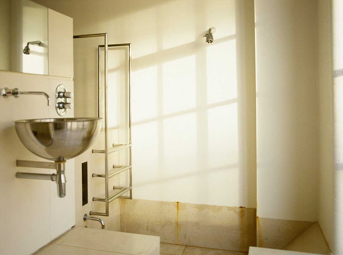Wall mounted stainless steel washbasin in ensuite bathroom