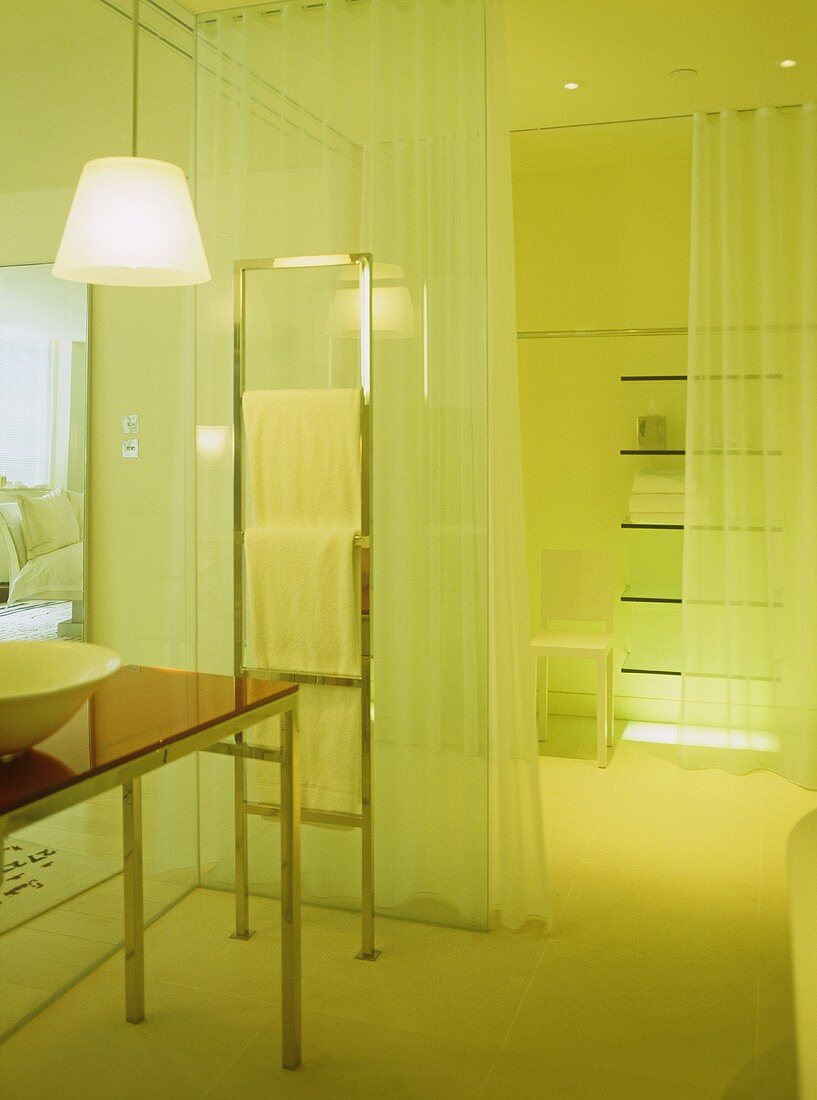 Hotelbad mit transparenter Glaswand und geschlossenem Vorhang