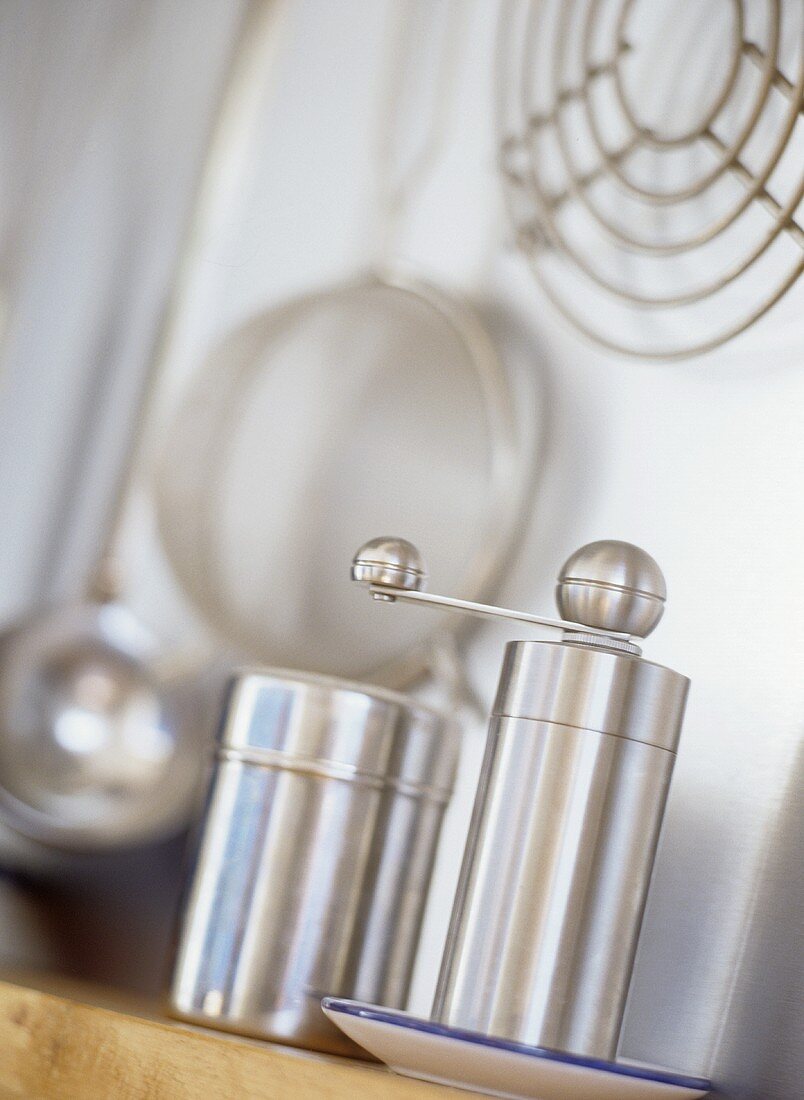 A stainless steel pepper mill and salt shaker