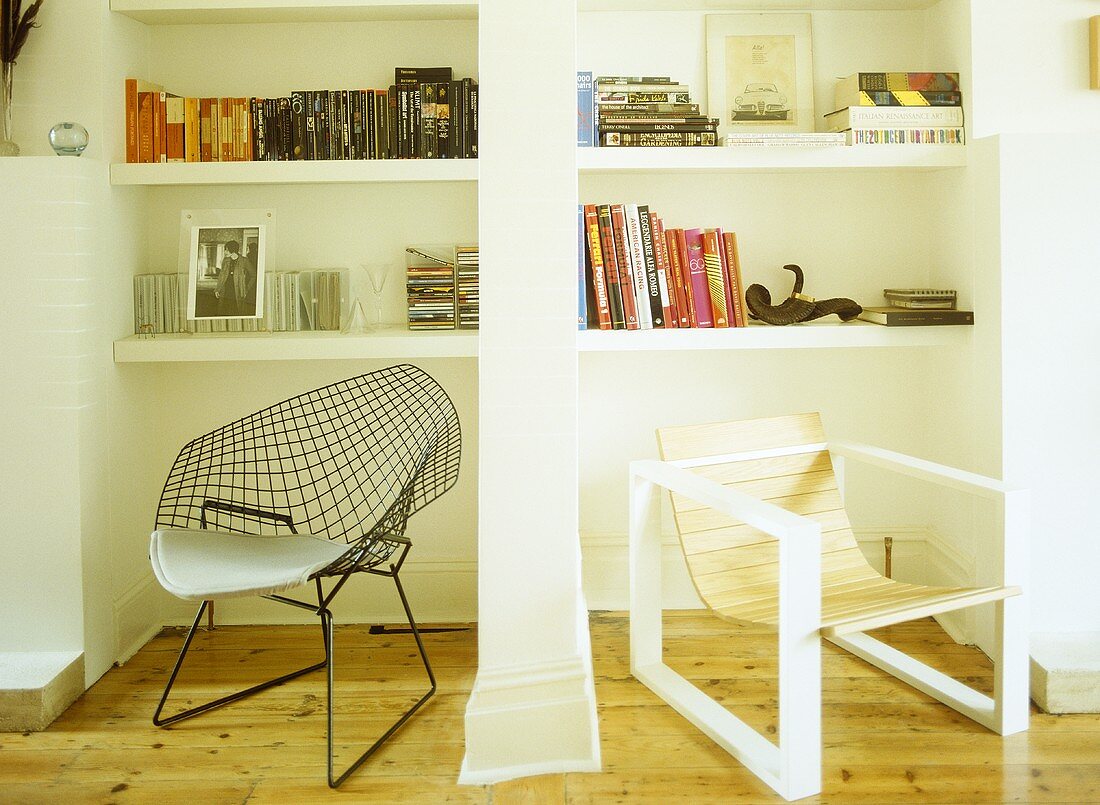 Two retro style chairs in front on white shelving unit