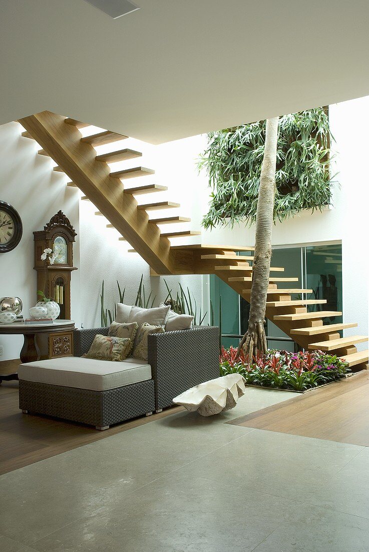 A sitting area with a flight of stairs and Dedon furniture