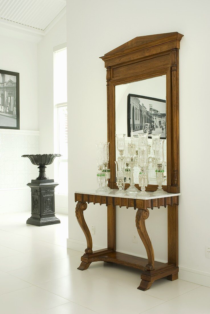 An antique wall table with a large mirror