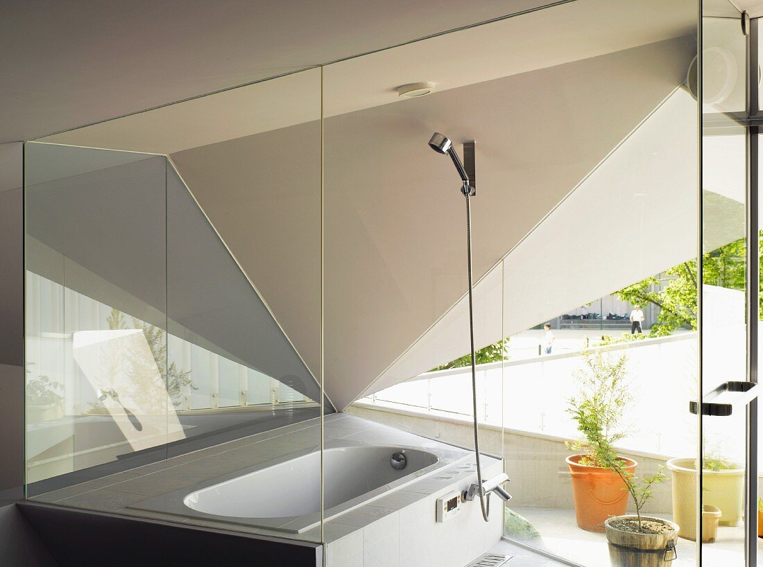 Bathtub in corner window below a dramatic, futuristic ceiling