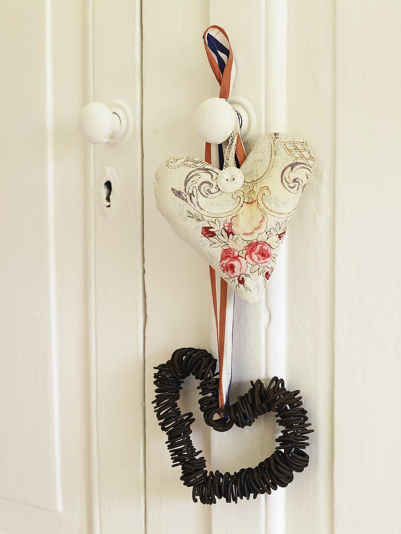 Heart shapes made of assorted materials hanging on a door knob