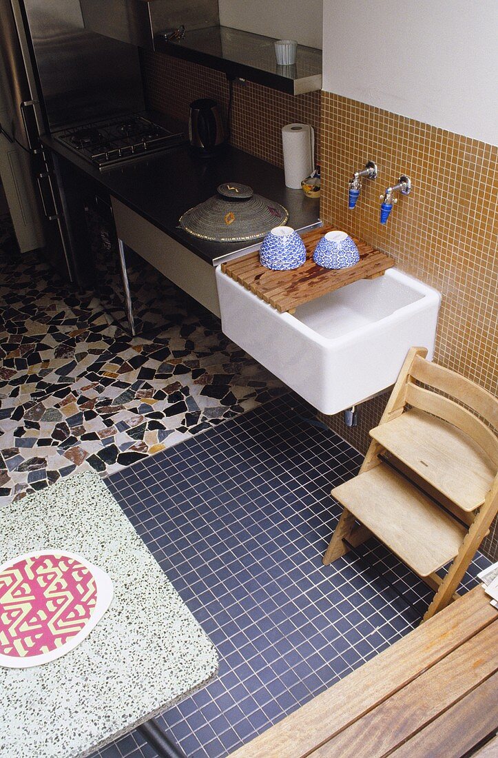 A range of tiling styles on a floor in a kitchen