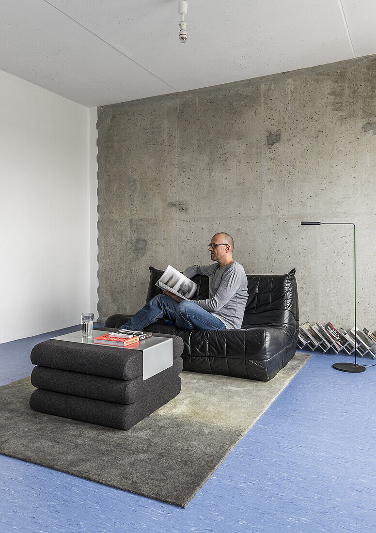 man in a modern prefab apartment in Berlin, Alexanderplatz, Berlin, Germany