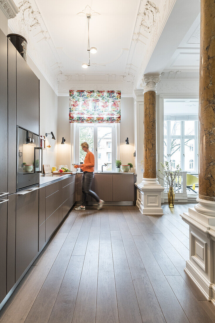 woman in the kitchen of a modern furnished Art Nouveau apartment in Hamburg, north Germany, Europe