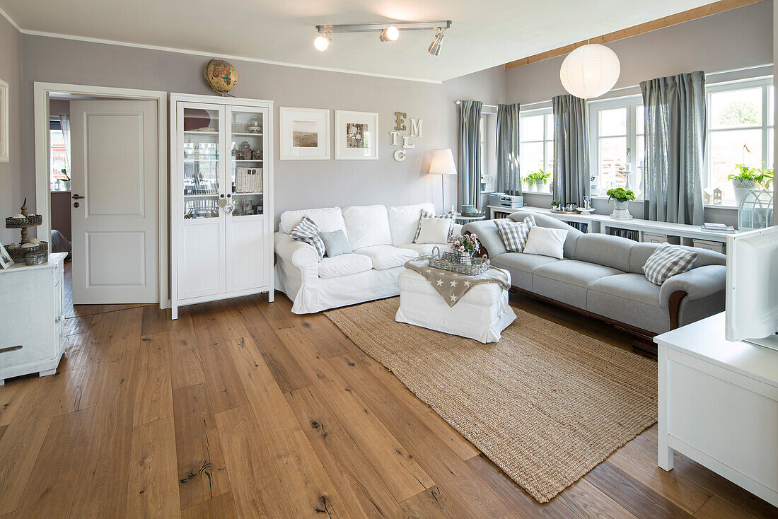 Modern Nordic Living room in family house with white and gray furniture and wooden floor, Korbach, Hesse, Germany, Europe