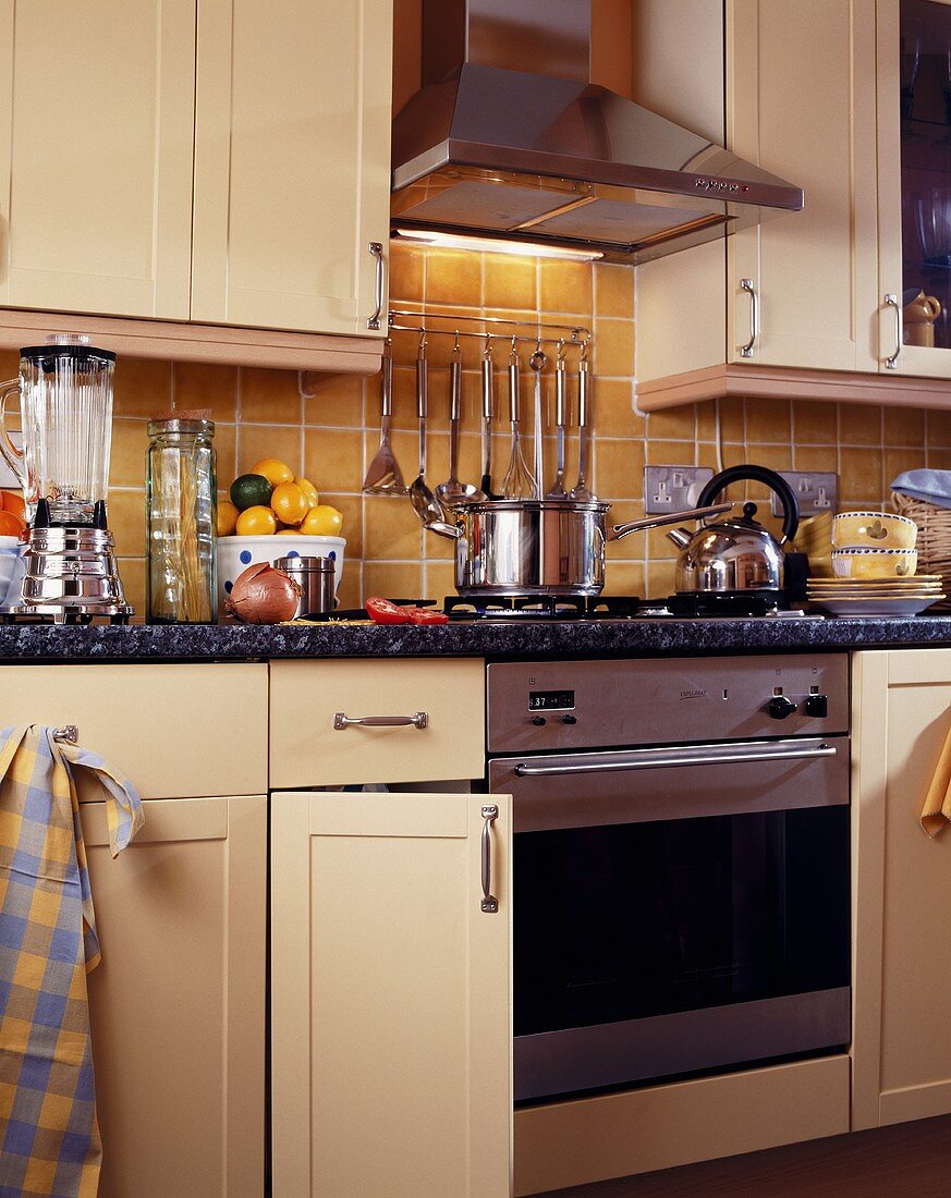 Moderne Landhausküche mit Edelstahl-Dunstabzug über Küchenofen