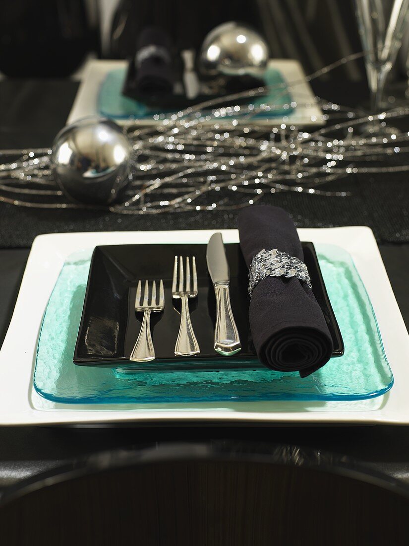 A festively Christmas place setting in blue and silver