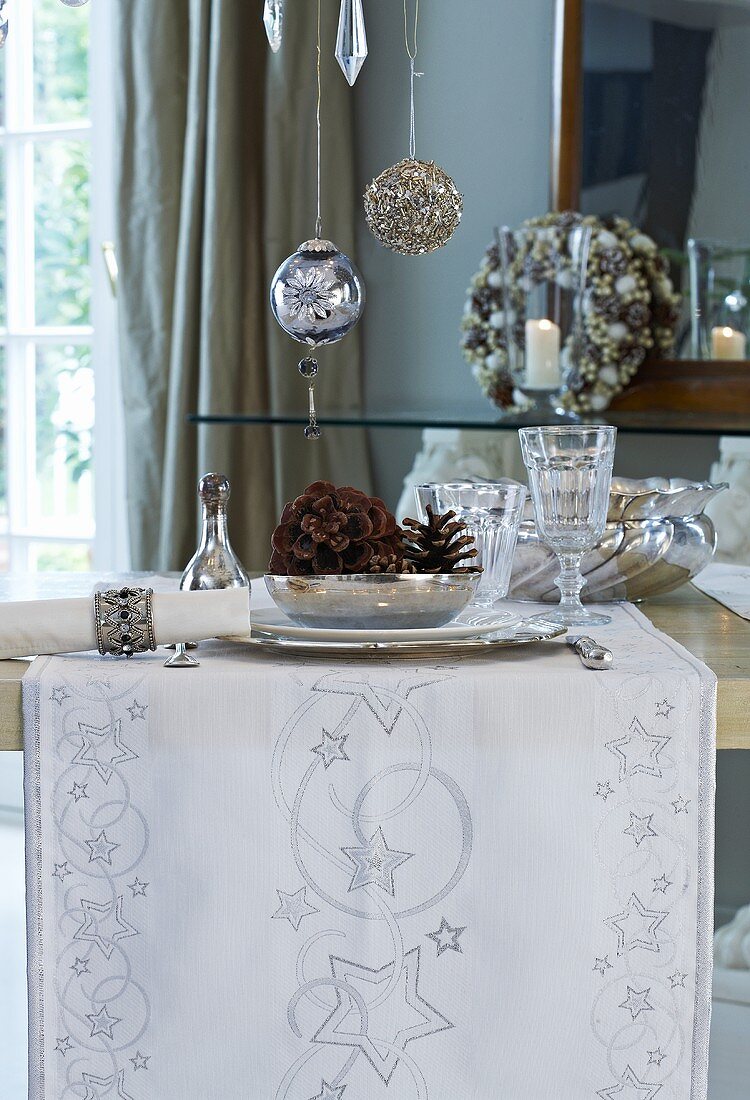 Weihnachtlich gedeckter Tisch mit Gläsern und Silberschalen
