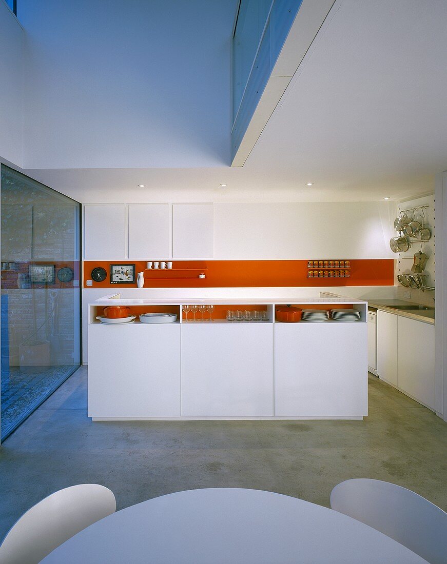 An open-plan, designer kitchen in red and white