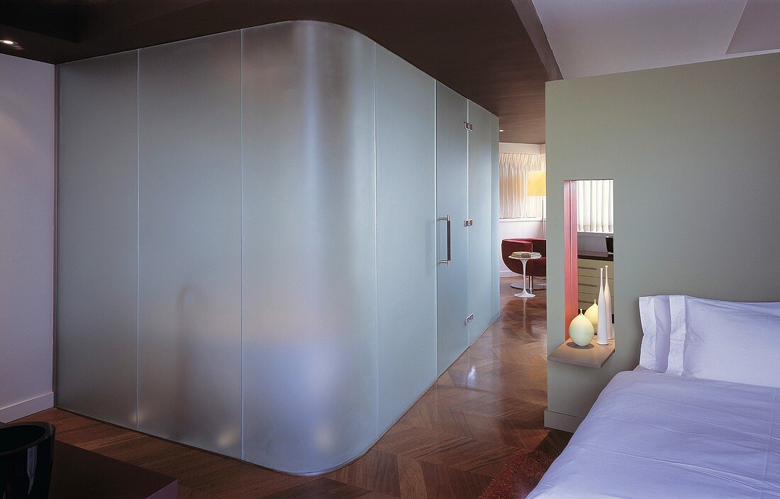 An open bedroom with a built-in bathroom