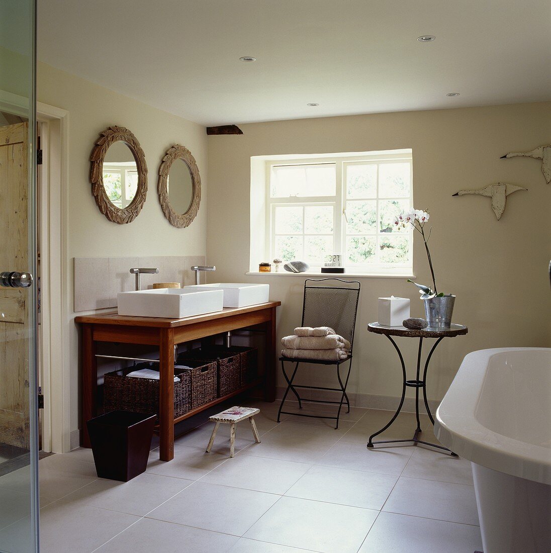 Rechteckige, weiße Becken auf Holzwaschtisch mit Regal für Körbe in modernem Bad mit weißem Fliesenboden