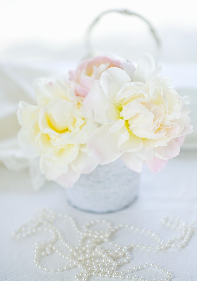 White peonies and a pearl necklace