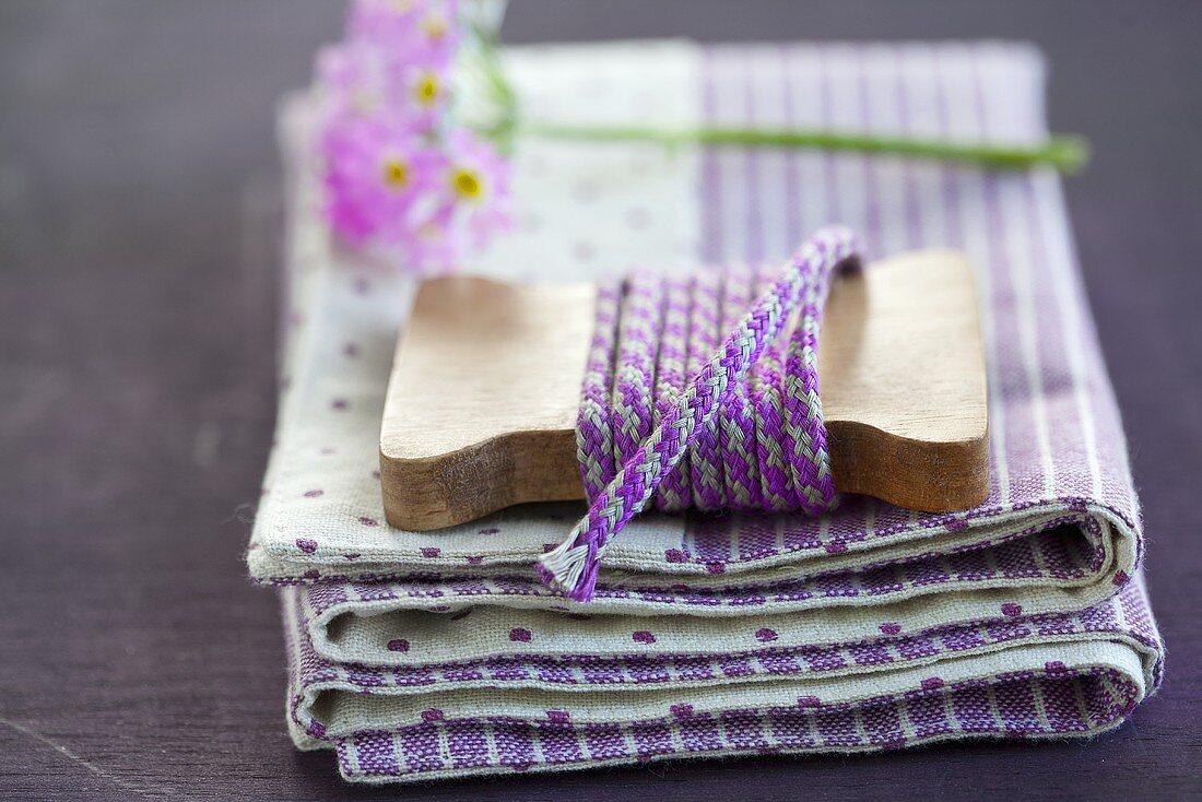 Purple cord for tying flowers on a pile of napkins