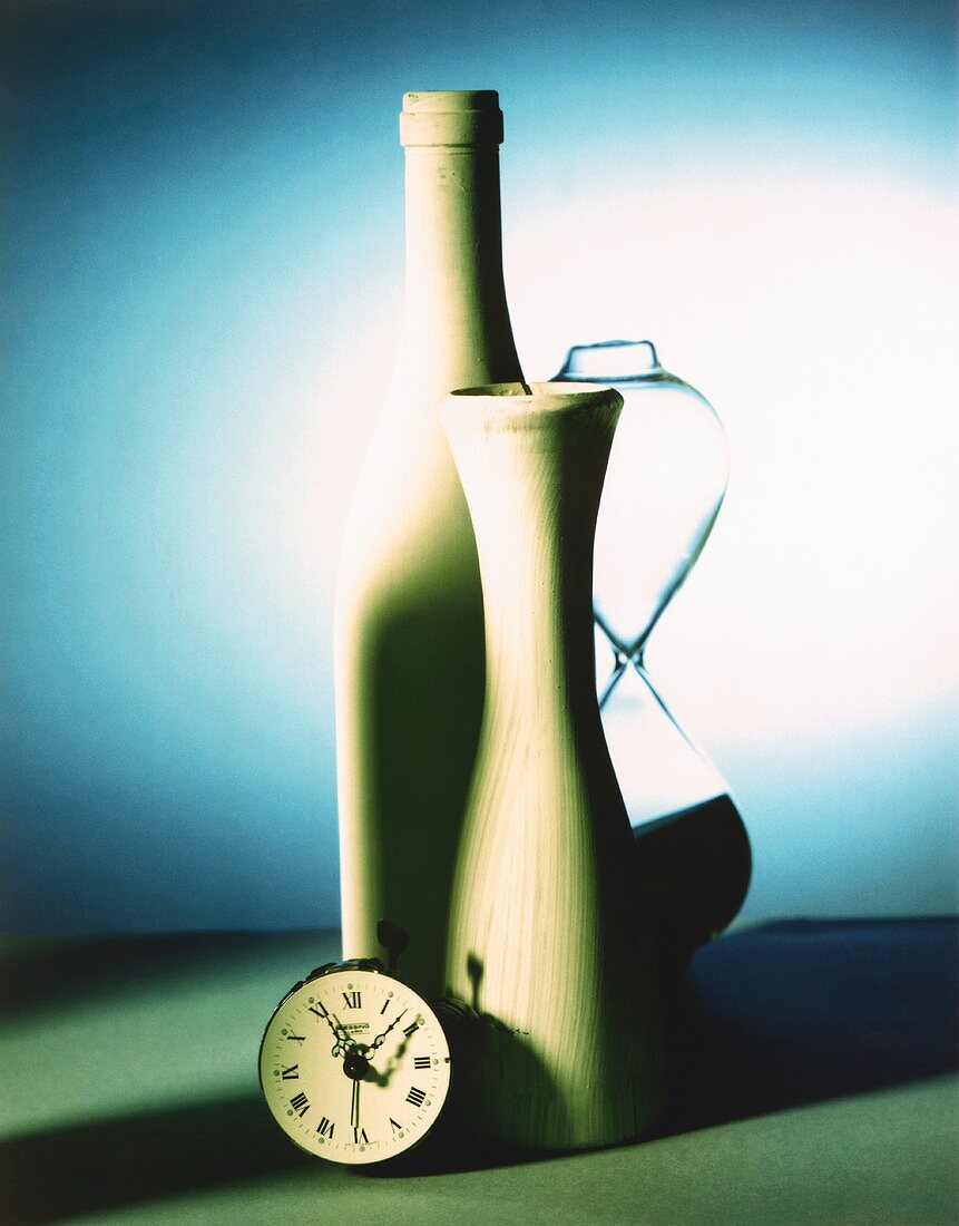 Still life with alarm clock, vase, bottle and hourglass