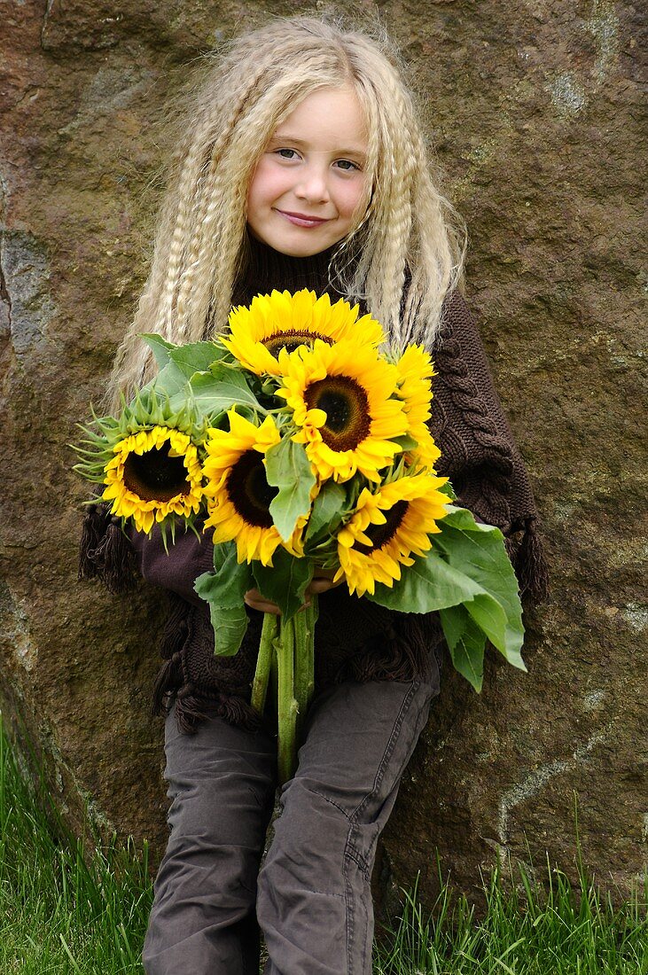 Blond girl with sunflowers