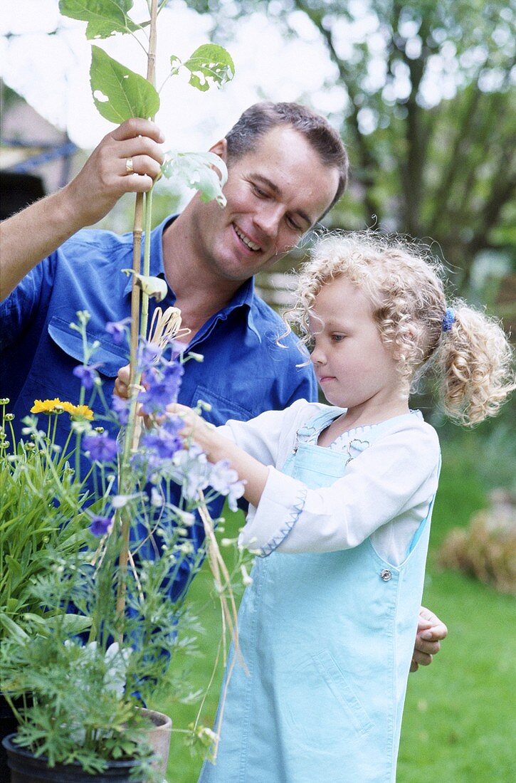 A father and daughter working in a garden