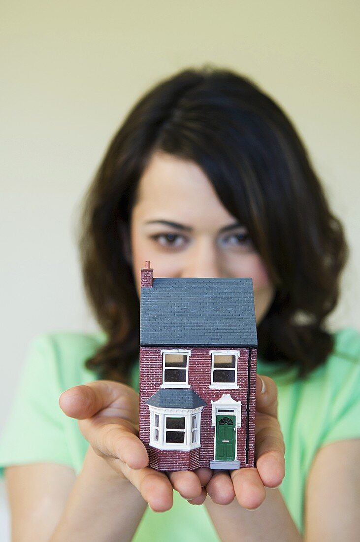 Woman holding a house