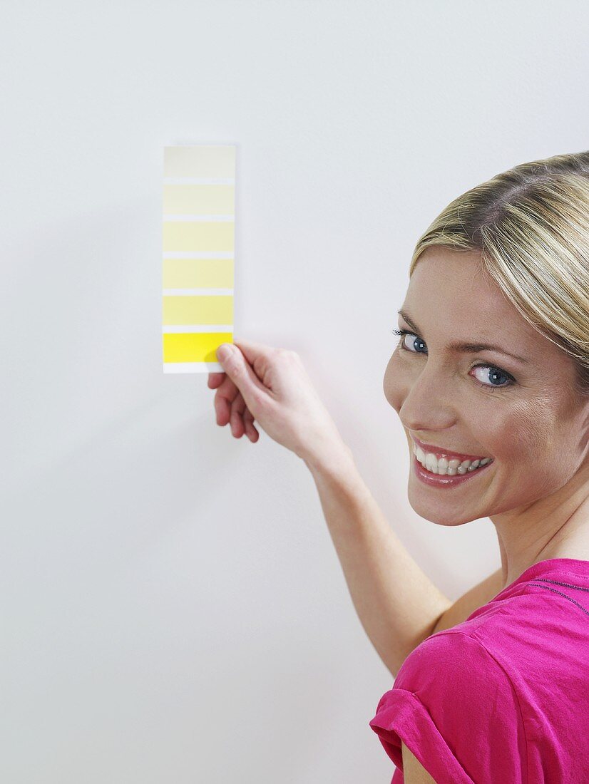 A woman holding a colour chart
