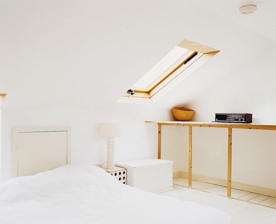 A loft bedroom with a skylight