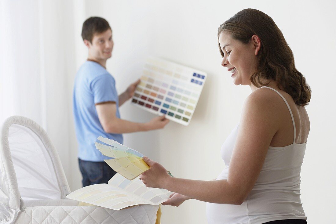 A couple choosing colours for a wall