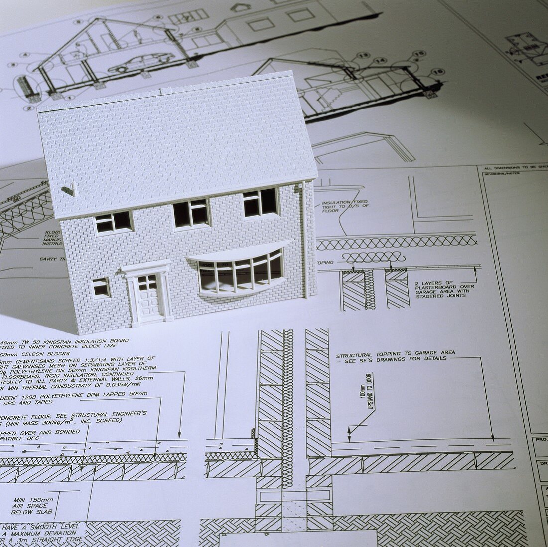 A model house and architectural blueprints