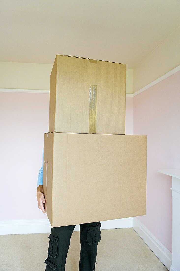 A person holding cardboard boxes