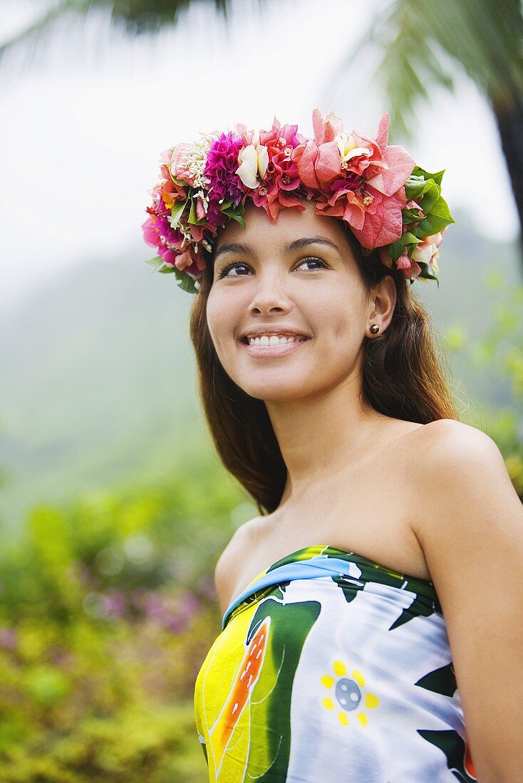 Young woman with flowers in hair in moorea