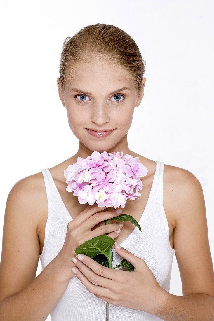 Young woman with a hydrangea flower