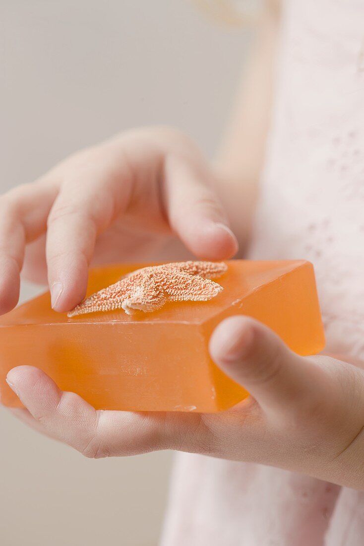 Girl holding soap with starfish