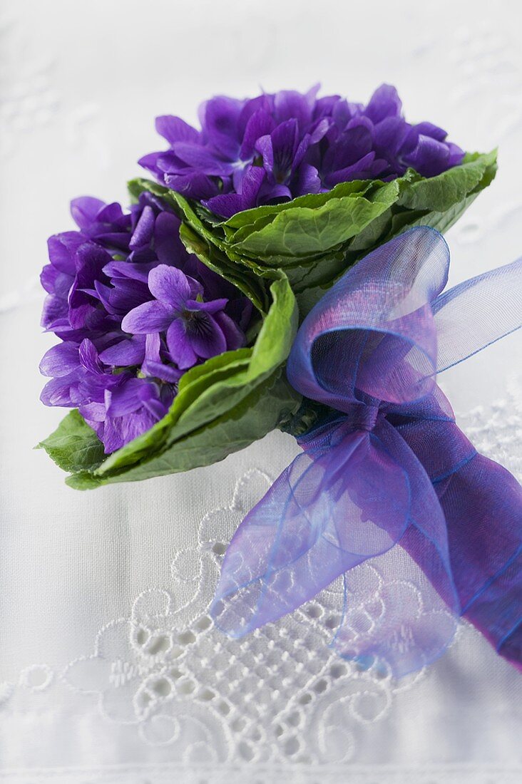 Bunch of violets with purple bow
