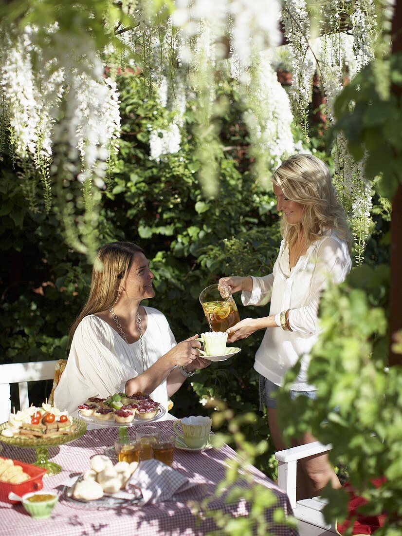 Two women having tea in a garden